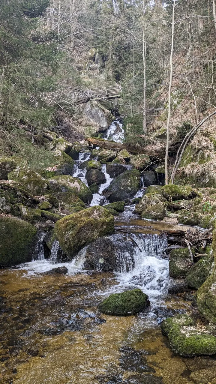 Waterfall below a bridge